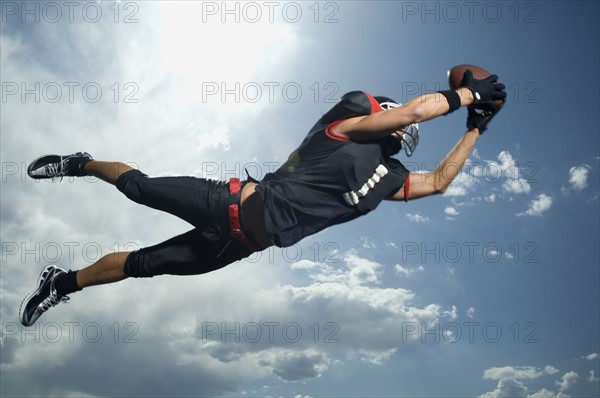 Low angle view of football player jumping. Date : 2007