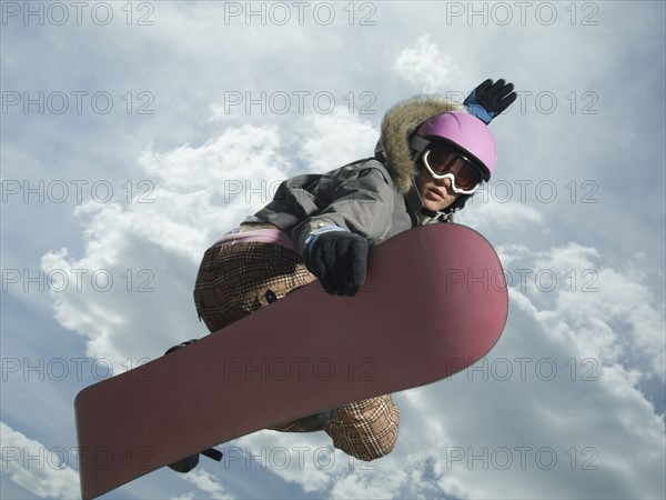 Low angle view of snowboarder jumping. Date : 2007