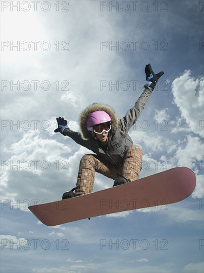 Low angle view of snowboarder jumping. Date : 2007