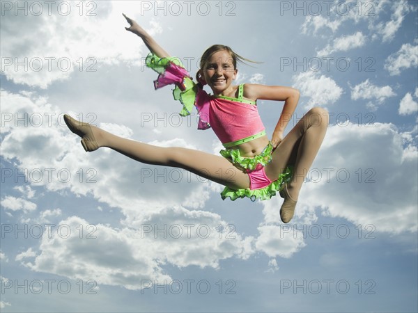 Low angle view of girl jumping. Date : 2007