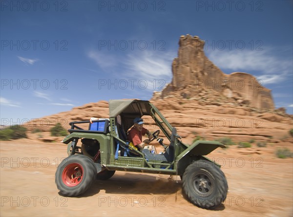 Man driving off-road vehicle in desert. Date : 2007