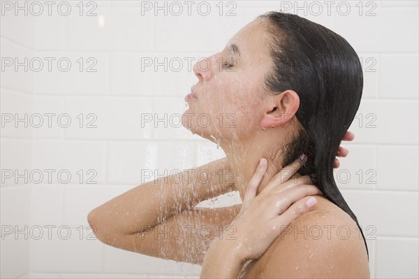 Woman standing under shower.