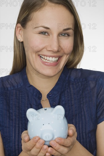 Woman holding piggy bank.