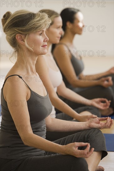 Multi-ethnic women practicing yoga.