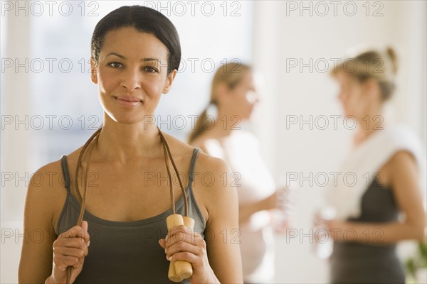 African woman holding jump rope.