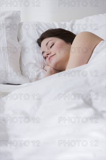 Woman sleeping in bed.