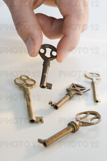 Man picking up old fashioned key.
