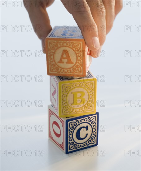 Man reaching for ABC blocks.