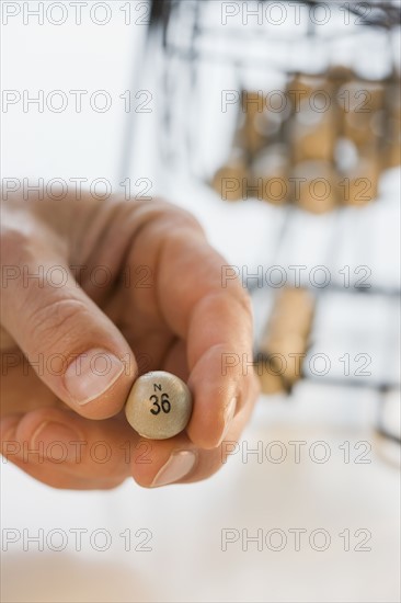 Man holding bingo ball.