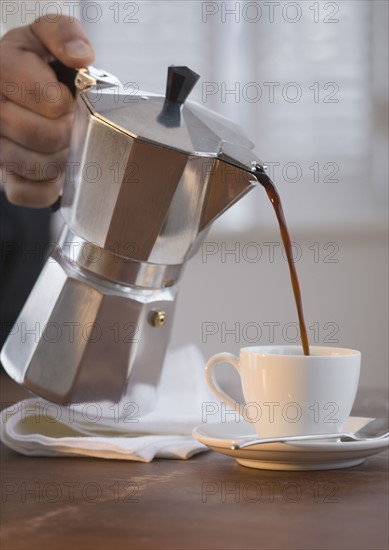 Man pouring espresso.