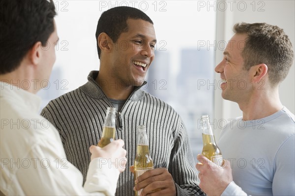 Multi-ethnic men drinking beer.