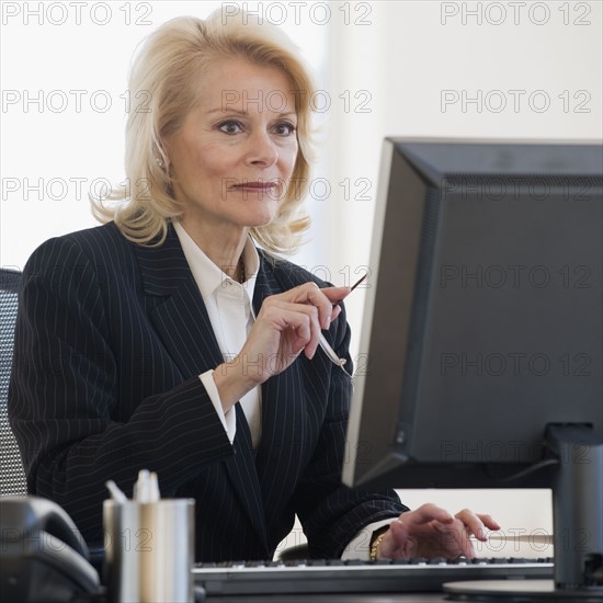Businesswoman looking at computer.