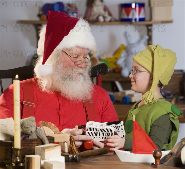 Santa Claus and elf with toys.