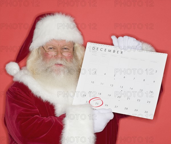 Santa Claus holding calendar.