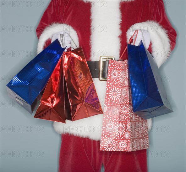 Santa Claus holding shopping bags.