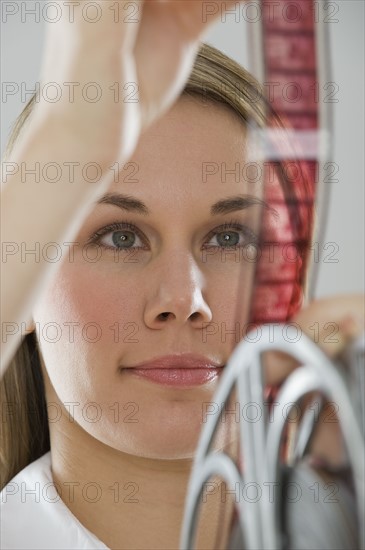 Woman looking at movie film.