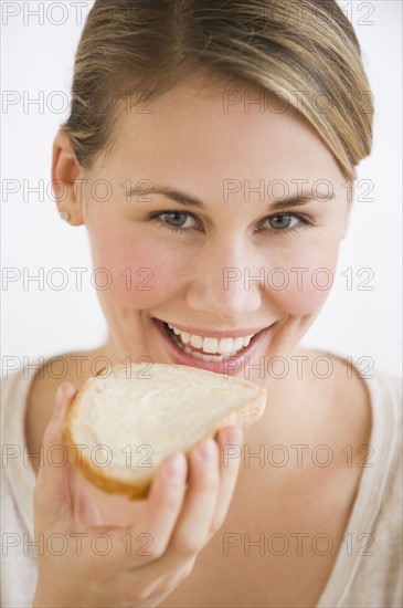 Woman eating bread and butter.