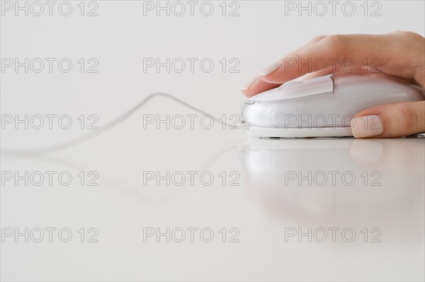 Woman’s hand on computer mouse.