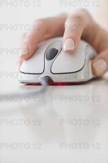 Woman’s hand on computer mouse.