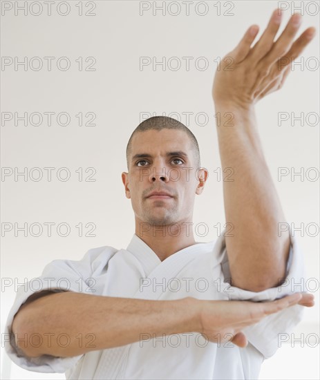 Hispanic man in karate fighting stance.