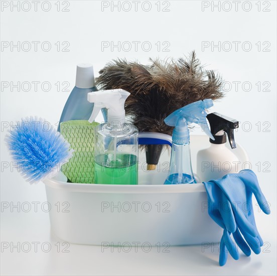 Bin of cleaning products and rubber gloves.