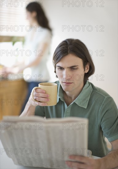 Man reading newspaper.