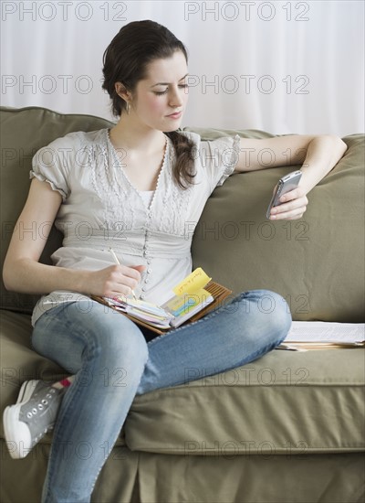 Woman looking at electronic organizer.