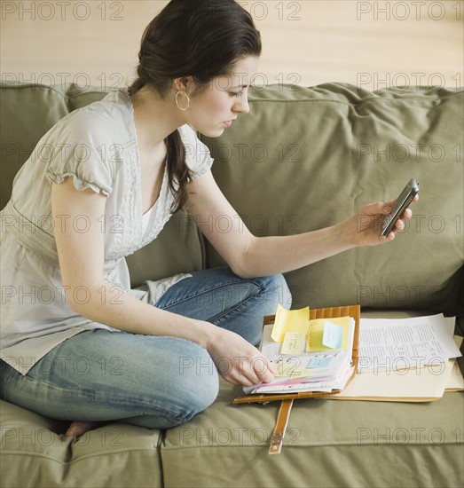 Woman looking at electronic organizer.