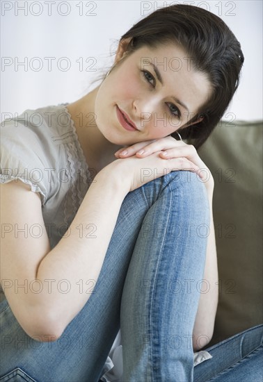 Woman resting head on knee.