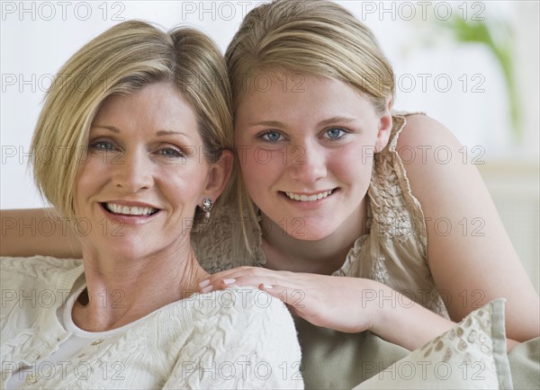 Mother and daughter hugging.