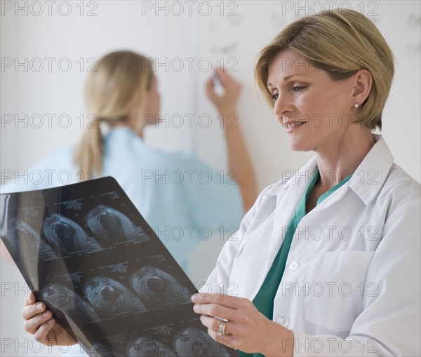 Female doctor looking at x-rays.