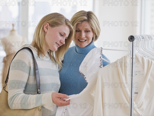 Mother and daughter clothes shopping.