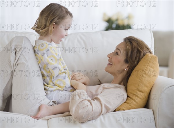 Mother and daughter smiling at each other.