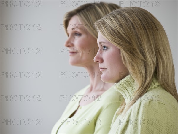 Mother and daughter standing next to each other.