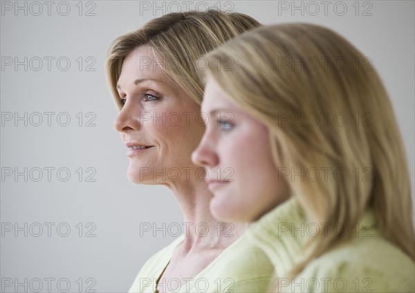 Mother and daughter standing next to each other.