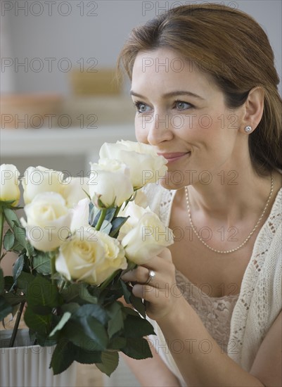 Woman smelling flowers.