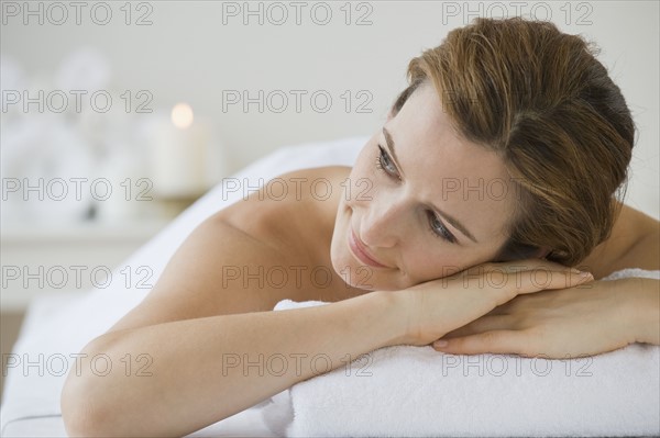 Woman laying on spa table.