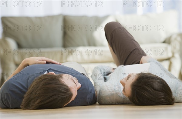 Couple laying on floor.