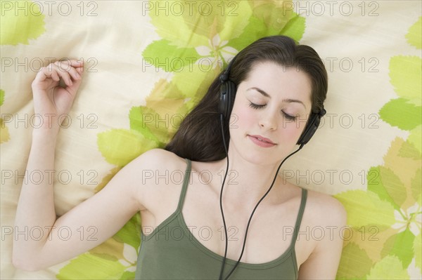 Woman listening to headphones.