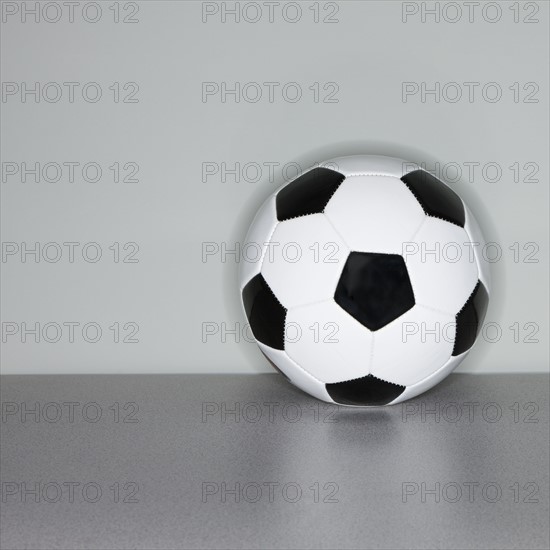 Soccer ball next to wall.