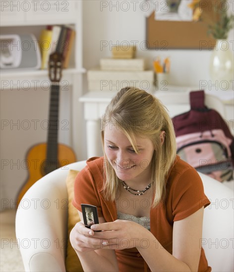Teenaged girl looking at cell phone.