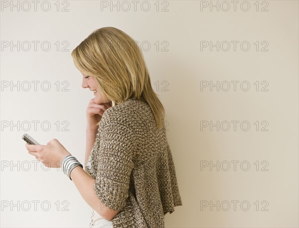 Teenaged girl looking at cell phone.