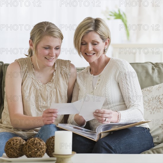 Mother and daughter looking at photo album.