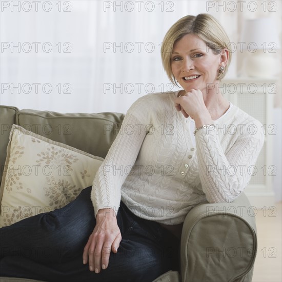 Woman sitting on sofa.