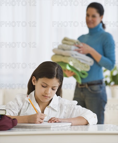 Hispanic girl doing homework.