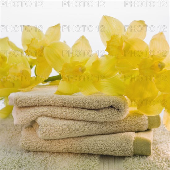 Flowers on stack of towels.