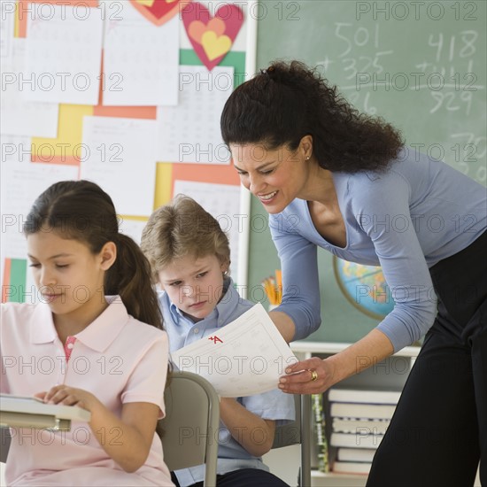 Hispanic teacher talking to student.