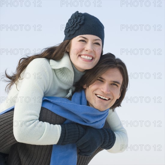 Couple in winter gear hugging.