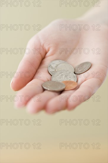 Coins in woman’s hand.