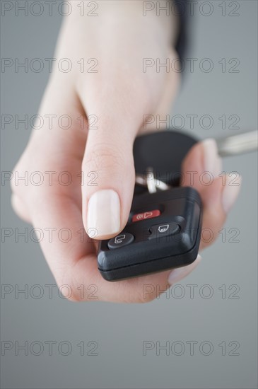 Woman pressing unlock button on keychain.